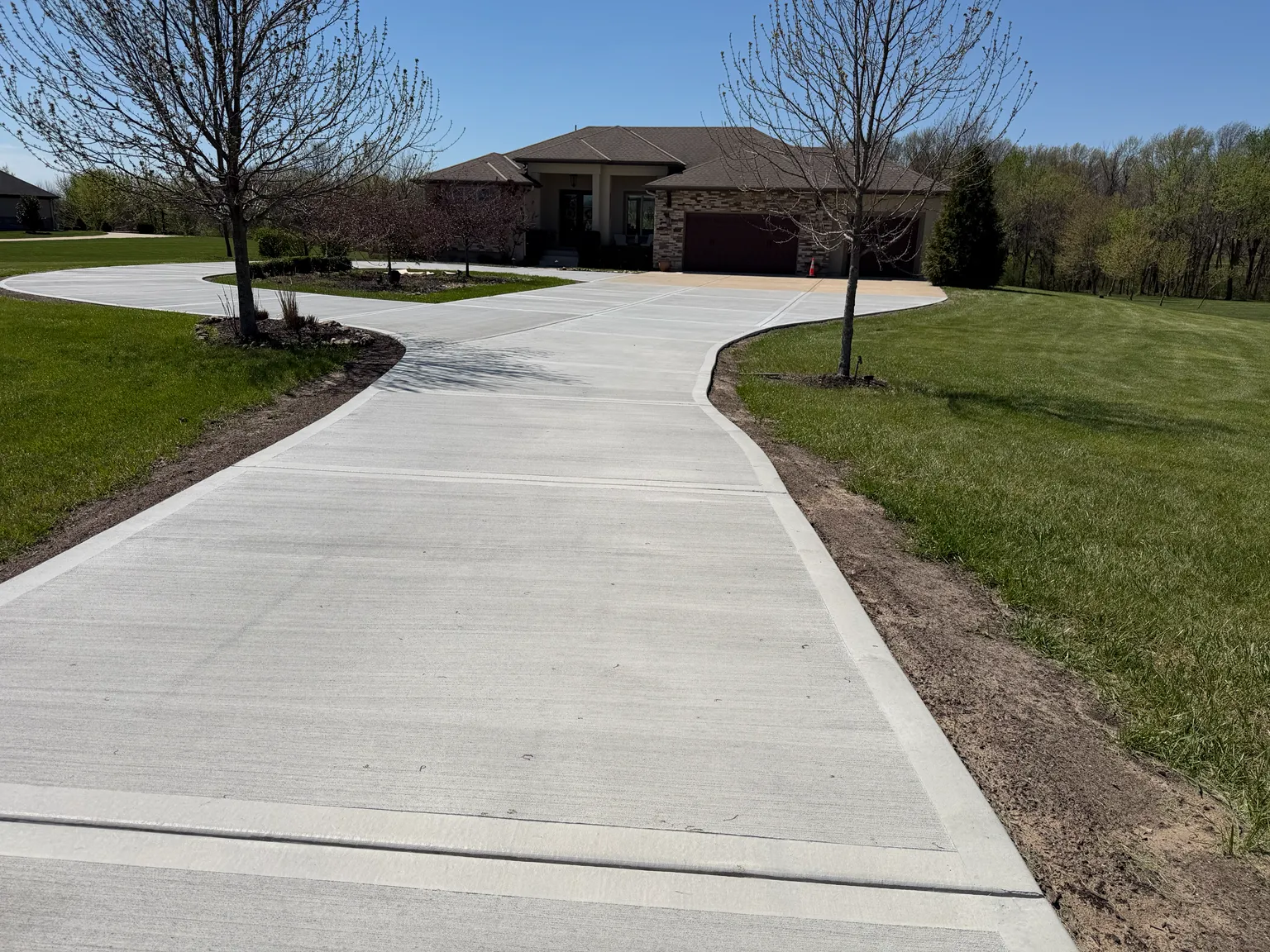 Finished curved concrete driveway at a residential property
