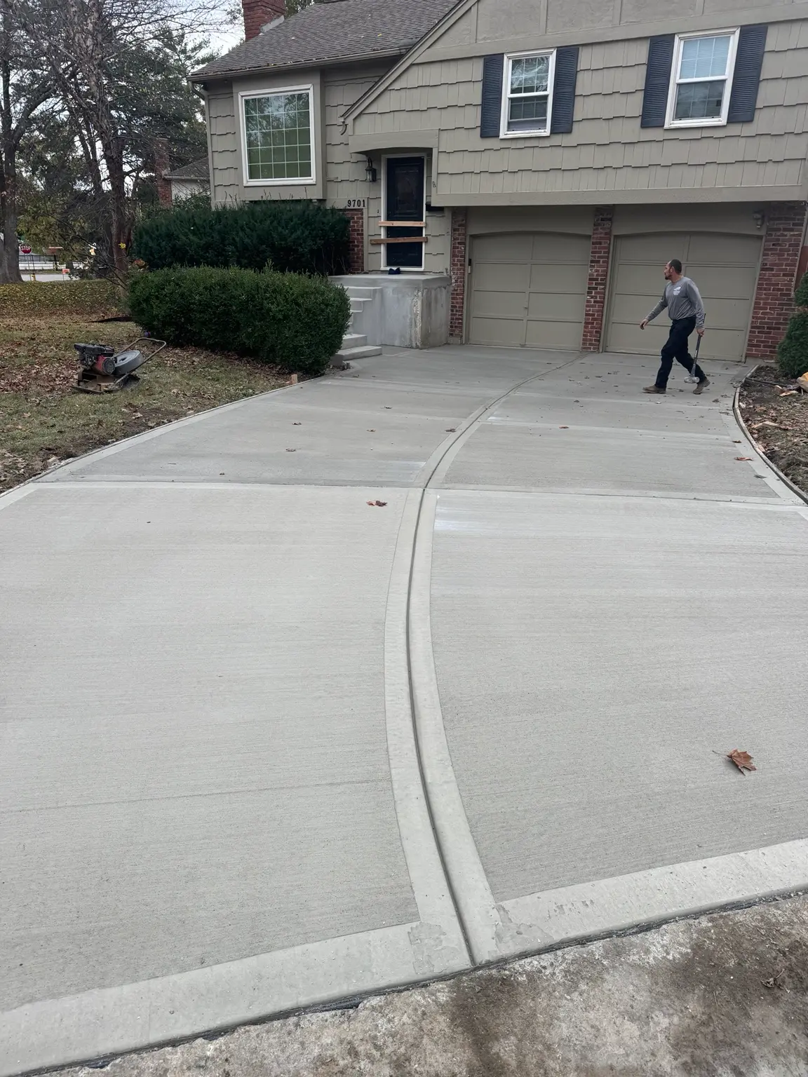 Freshly finished curved concrete driveway at a residential home