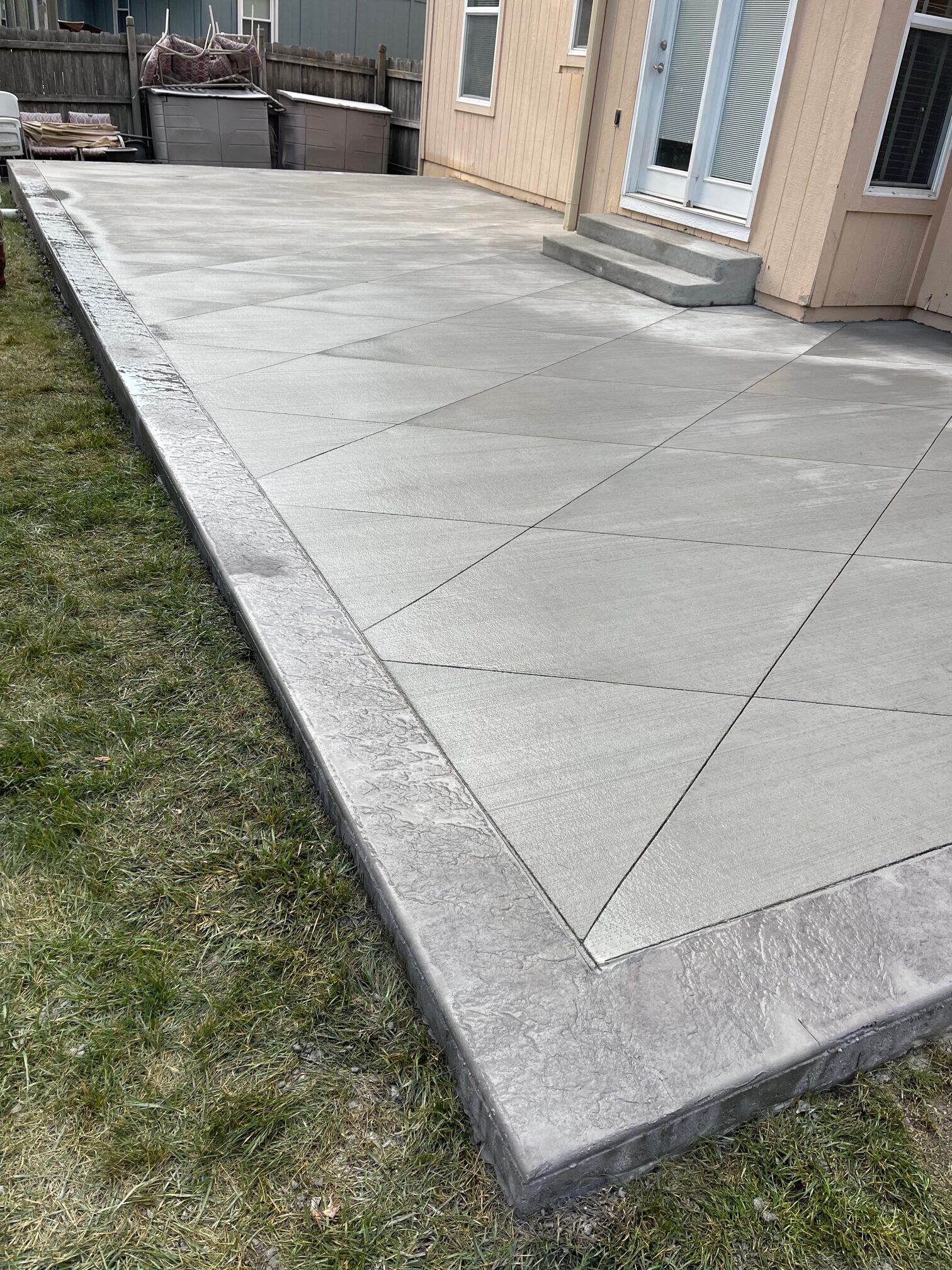 Finished concrete patio with decorative diamond saw cuts