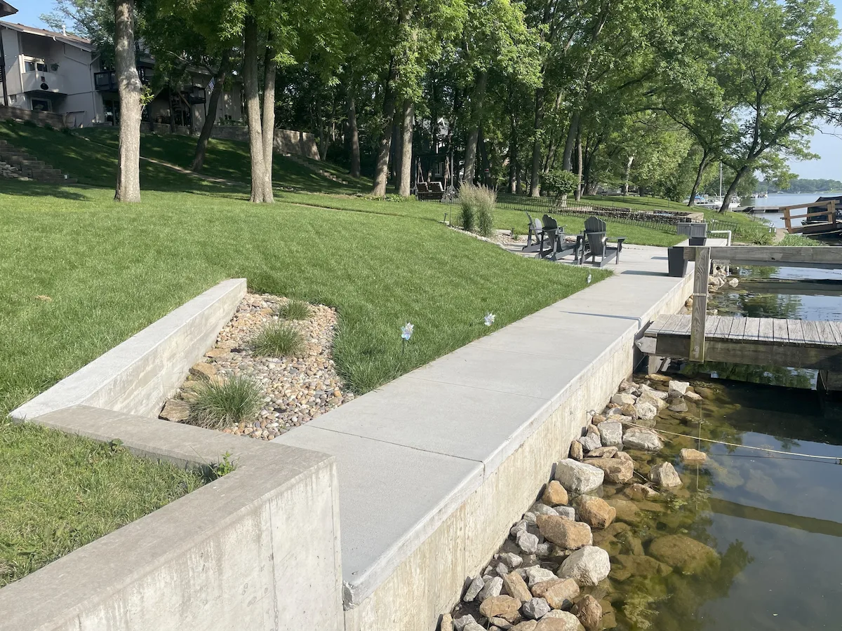 Concrete seawall and walkway along a residential lakefront