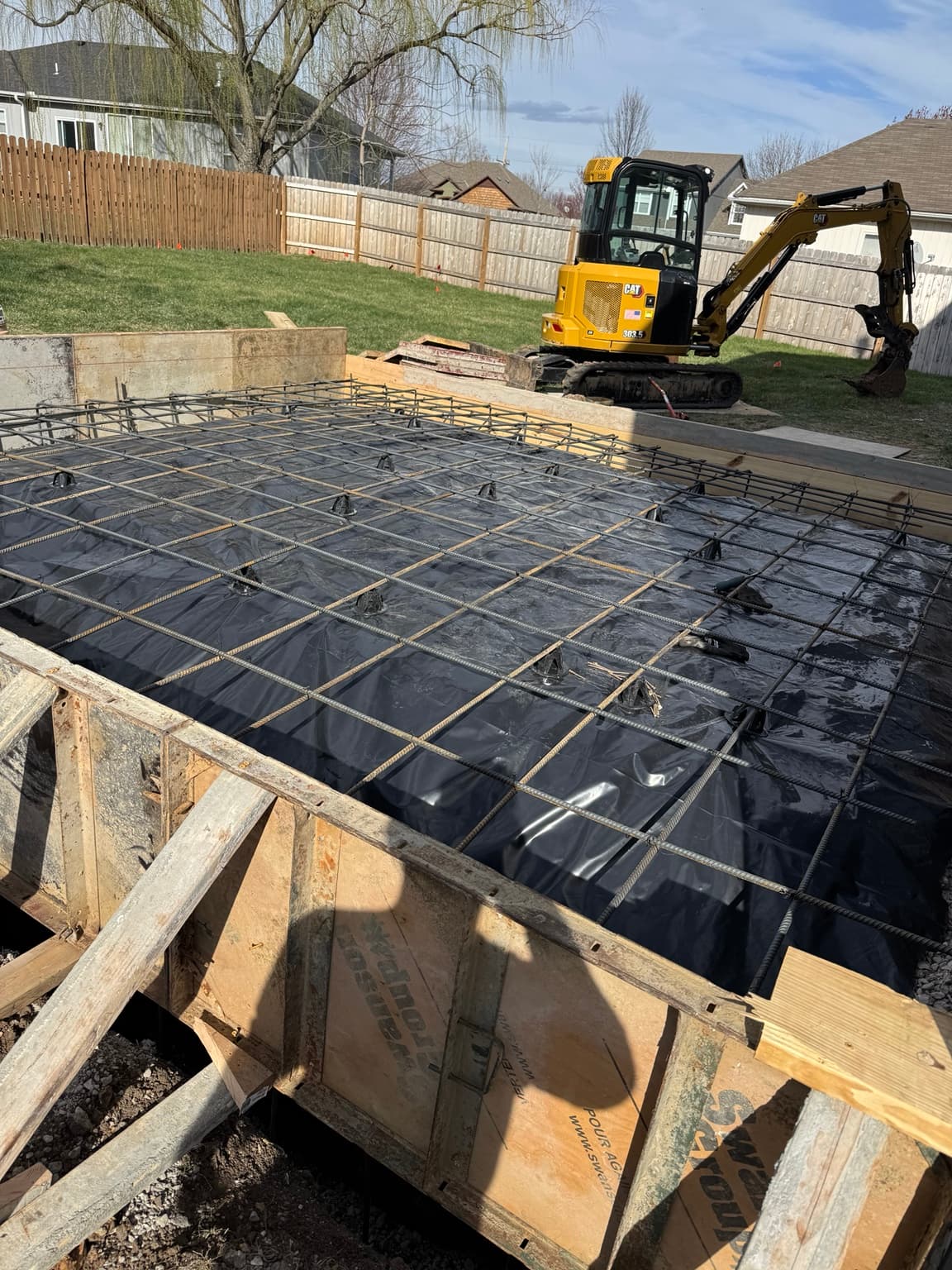 Reinforcement installed for a residential concrete foundation slab before concrete placement