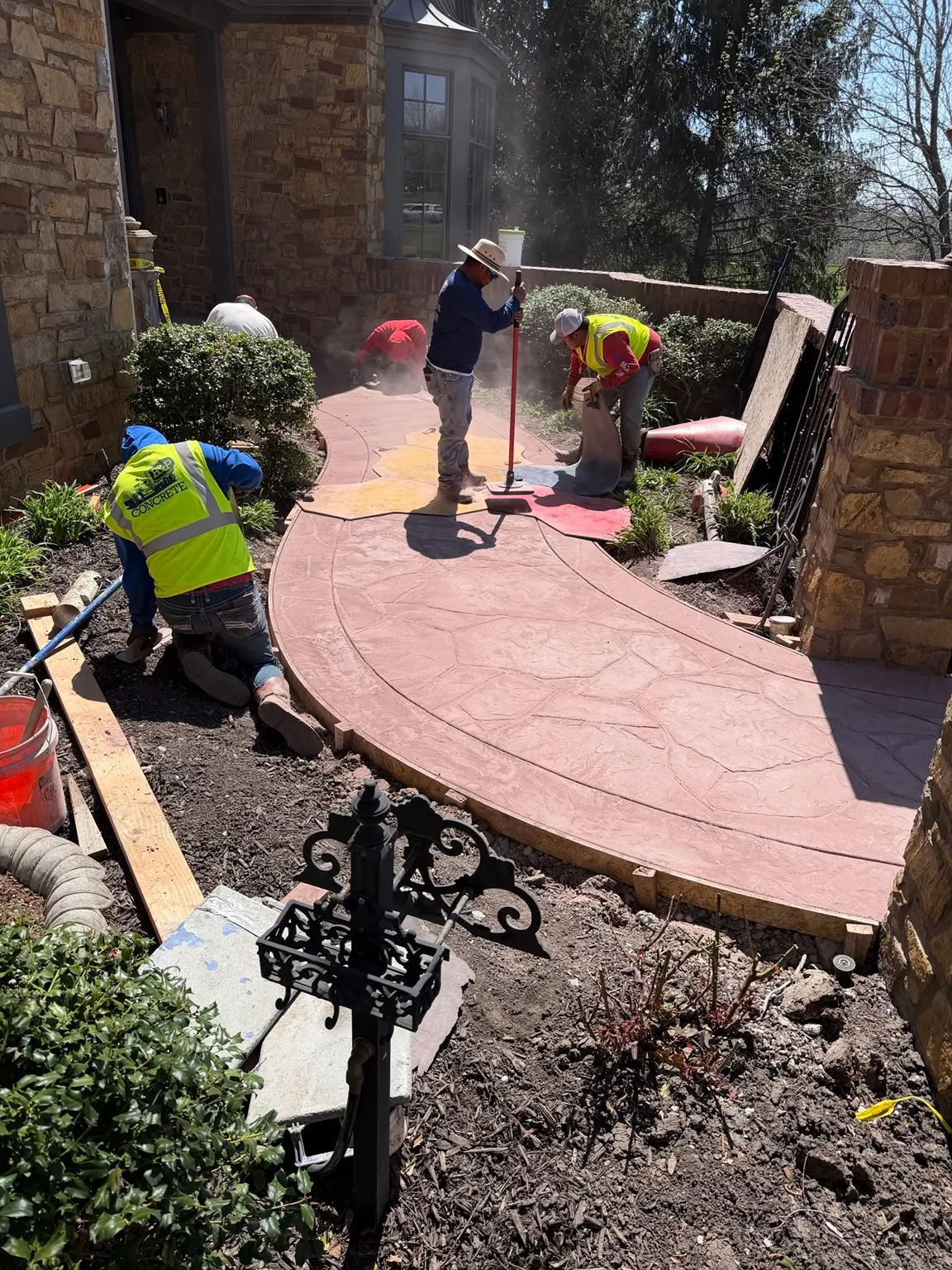 B&P Concrete crew stamping a curved decorative concrete project during installation