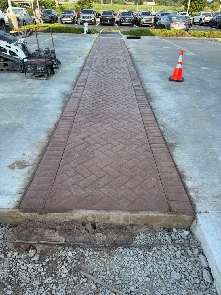 Decorative stamped concrete walkway in a commercial parking area